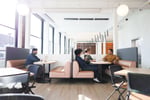 Spacious interior of Workbar Somerville showcasing modern lounge seating, flexible workstations, and abundant natural light.