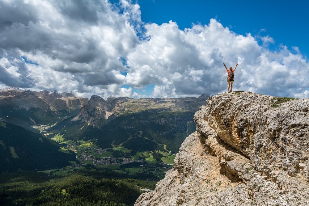 person on top of mountain recharged worker